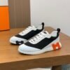 HRMS Mesh Low-Top Trainers – Black & White with Orange Detail